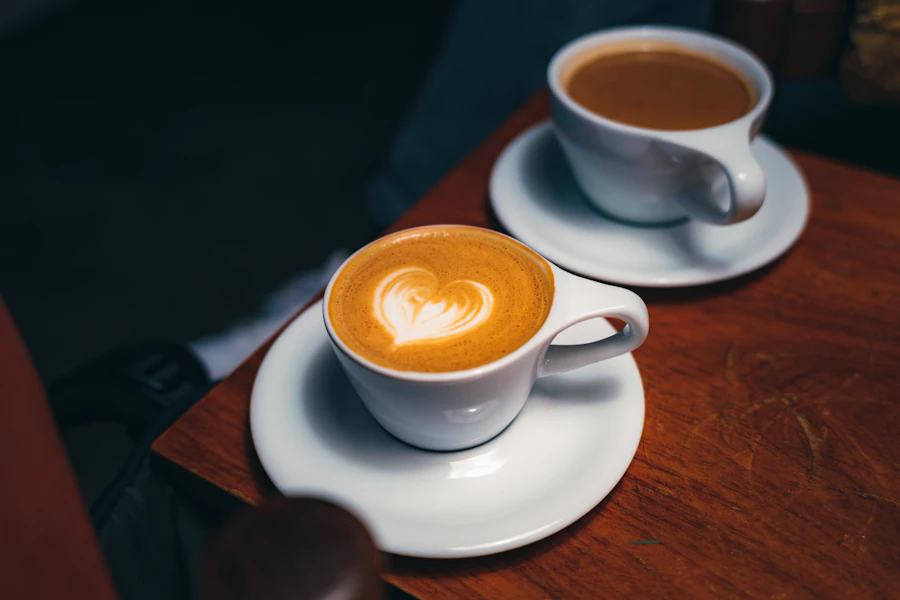 Two cups of coffee on a wooden table.
